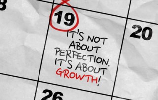 Concept image of a Calendar with the text: Its Not About Perfection Its About Growth